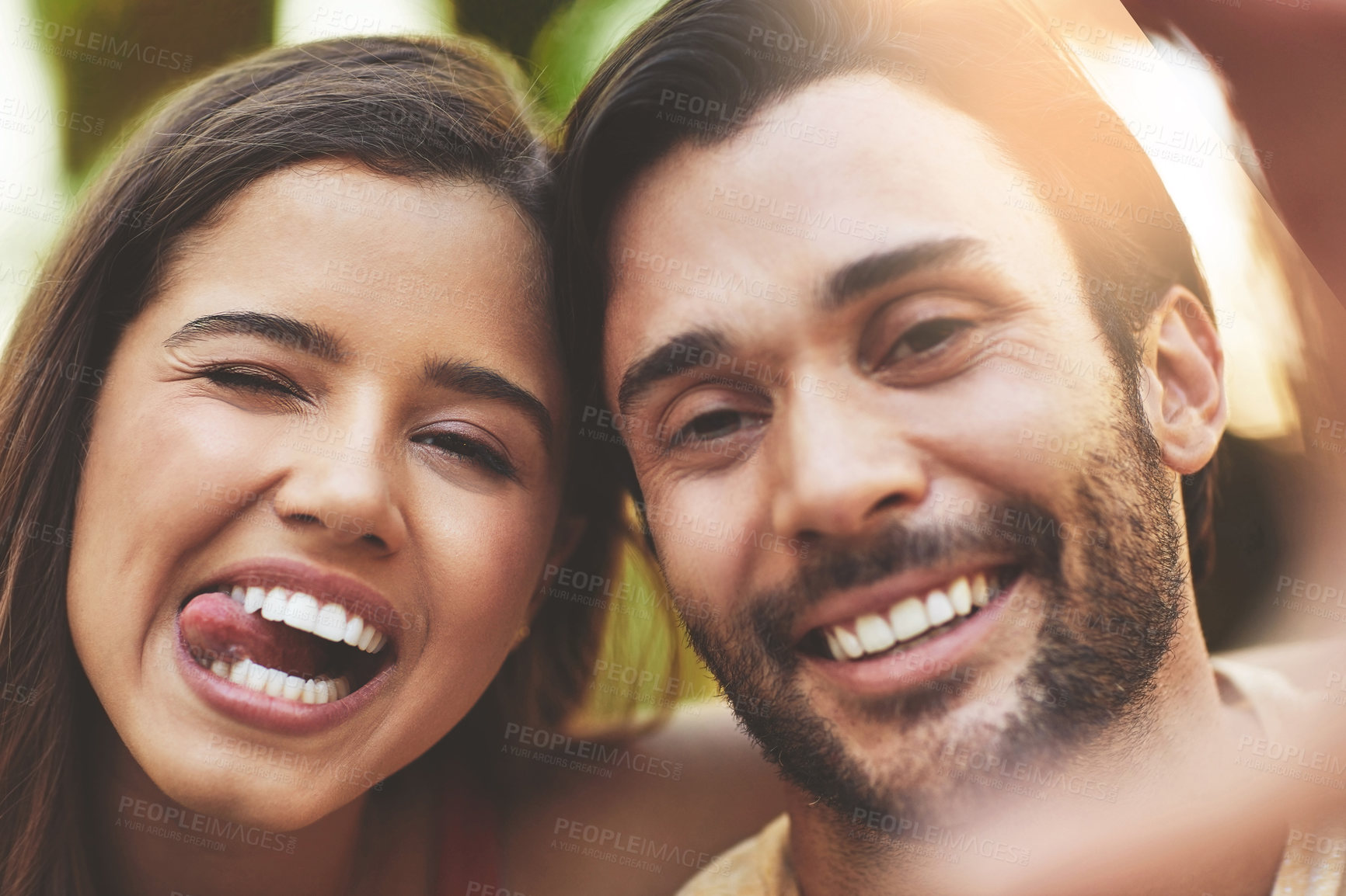 Buy stock photo Couple, selfie and tongue out in portrait, outdoor and smile with love for post on social media. Man, woman and happy with photography for profile picture, funny face and laughing with memory in park