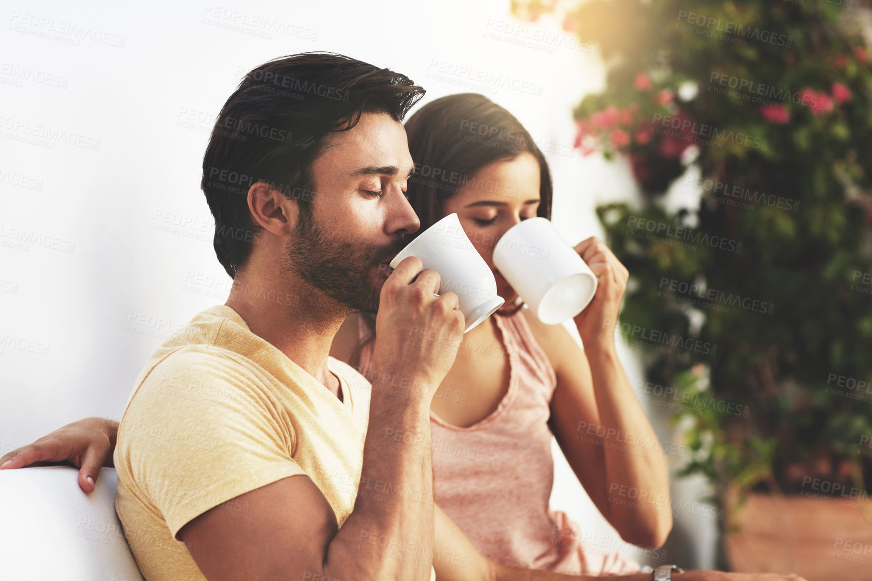 Buy stock photo Couple, drinking tea and outdoor for peace on vacation, morning support and together on trip. People, backyard and love for coffee on holiday, hot chocolate and relax on patio for calm beverage