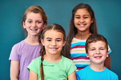 Buy stock photo Friends, happy and portrait of kids on blue background for back to school, education and academy. Students, youth and group of children with smile for learning, scholarship and diversity in studio