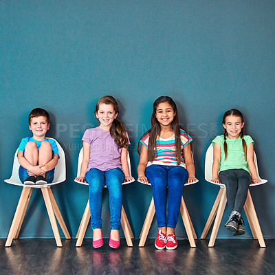 Buy stock photo Children, chair and row with portrait in studio for knowledge, development or learning in school. Happy, students and kids with smile at academy for education, scholarship or academic growth together