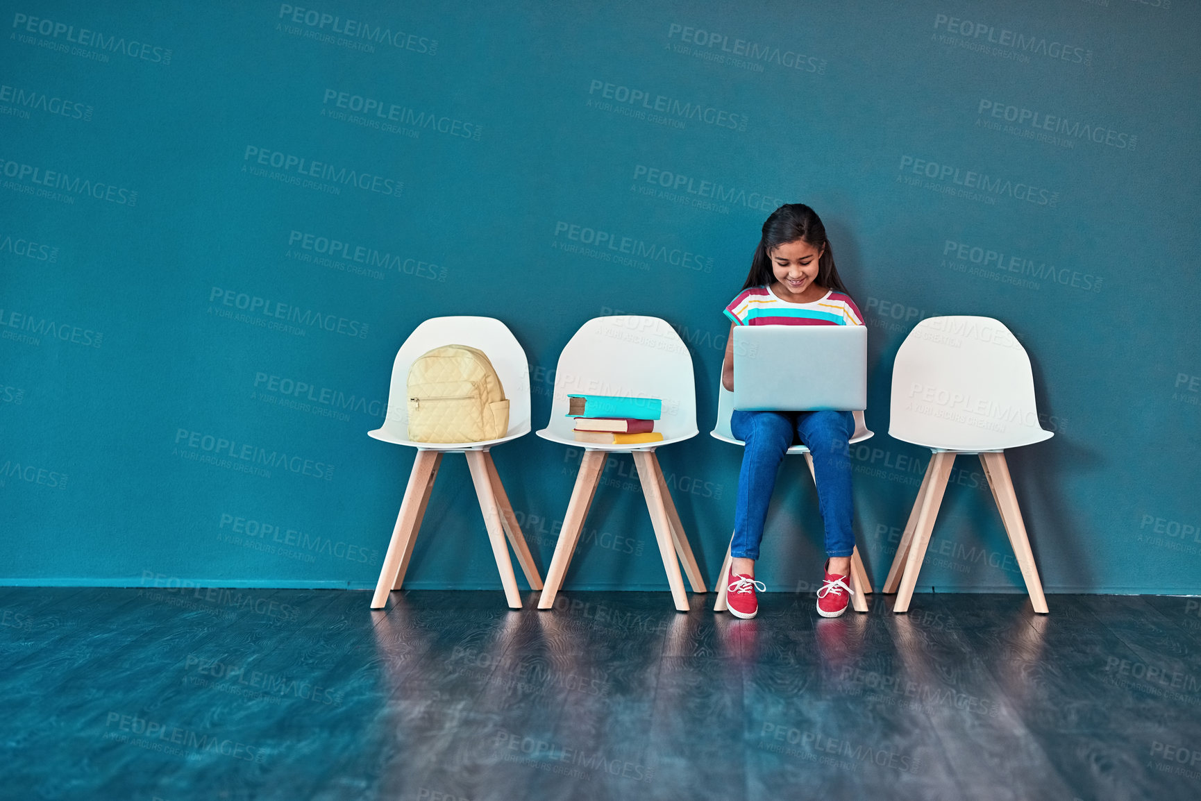 Buy stock photo Admission, laptop and learning with girl student in waiting room of school for entrance exam or interview. Chairs, children and computer with education candidate getting ready for academic assessment