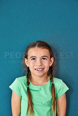 Buy stock photo Girl, child and happy with thinking on mockup with question, imagination and curiosity on blue background. Person, uncertain kid and thoughtful with wondering, daydreaming and contemplating on space