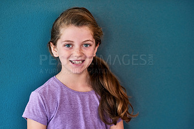 Buy stock photo Girl, kid and portrait with smile in studio, happiness for education in New York City. Female student, elementary grade and cheerful for knowledge in classroom, back to school on blue background