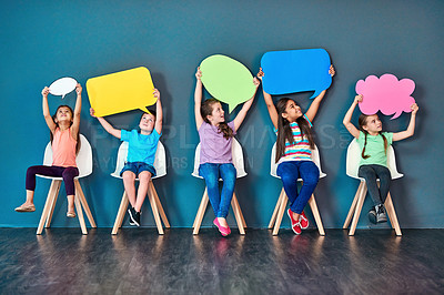 Buy stock photo Speech bubble, happy and children on chair in studio for omg news, opinion and feedback on wall background. Mockup space, social media and kids with sign for information, announcement and banner