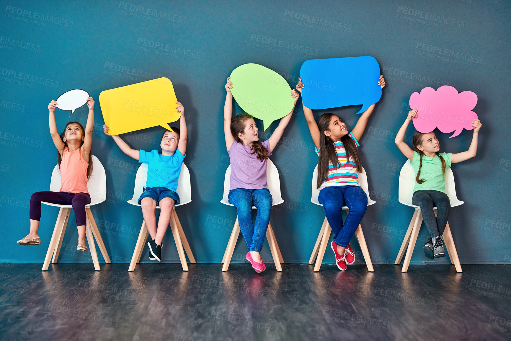 Buy stock photo Speech bubble, happy and children on chair in studio for omg news, opinion and feedback on wall background. Mockup space, social media and kids with sign for information, announcement and banner