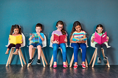 Buy stock photo Children, education and row with books in studio for knowledge, development and studying for test. Chair, kids and students reading with paper for school learning, scholarship and academic growth