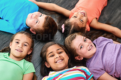 Buy stock photo Above, happy and portrait of kids on floor for playing, friendship and bonding in classroom. Diversity, youth and group of children smile in circle for learning, education and development at school