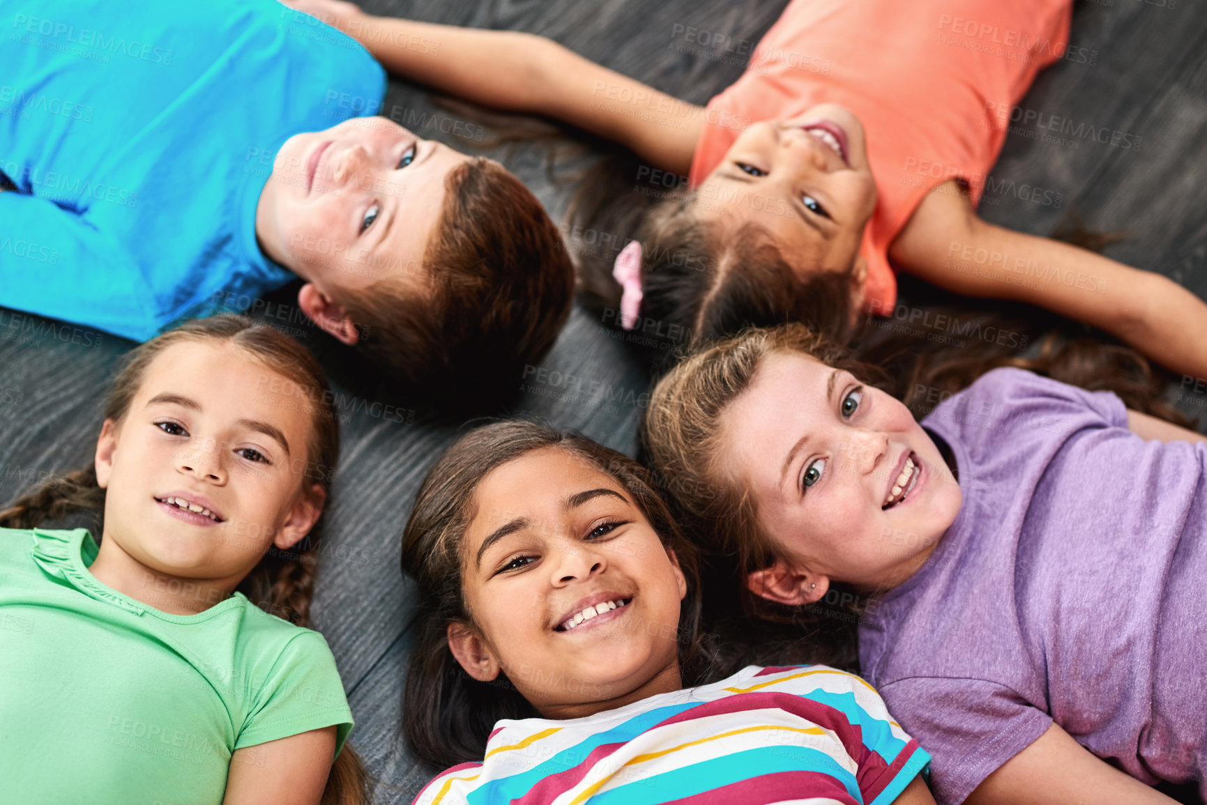 Buy stock photo Above, happy and portrait of kids on floor for playing, friendship and bonding in classroom. Diversity, youth and group of children smile in circle for learning, education and development at school