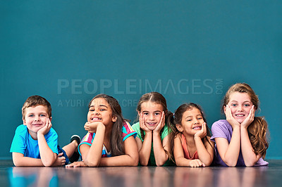 Buy stock photo Mockup space, happy and portrait of children on blue background for school, education and academy. Students, youth and group of kids on floor for learning, scholarship news and diversity in studio