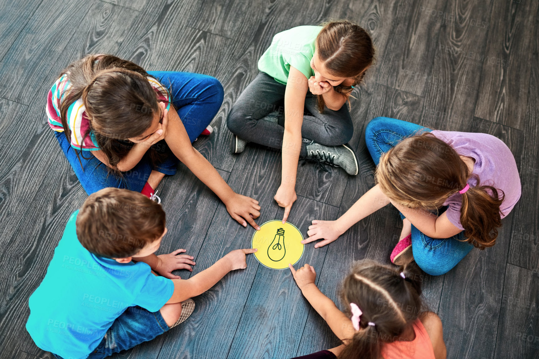 Buy stock photo Kids, pointing and playing a game on floor with lightbulb, decision making and learning. Diversity circle, people and problem solving with educational activity, solution and knowledge with top view