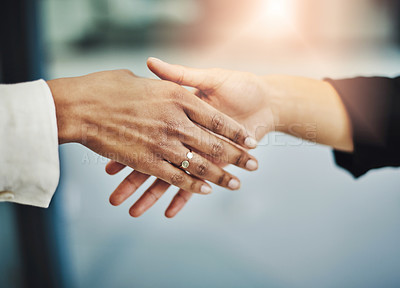 Buy stock photo Closeup shot of two businesswomen shaking hands in an office