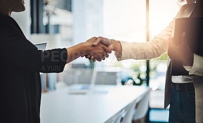 Buy stock photo Closeup shot of two businesswomen shaking hands in an office