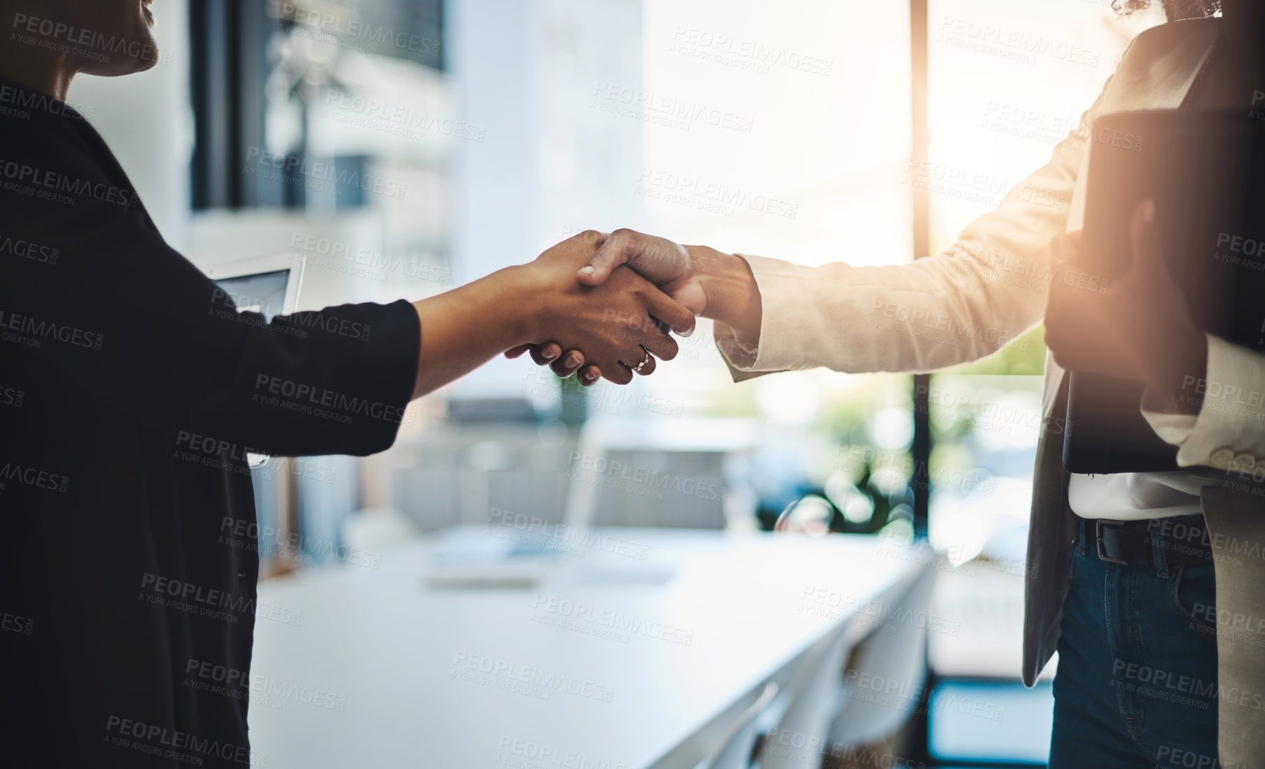 Buy stock photo Closeup shot of two businesswomen shaking hands in an office