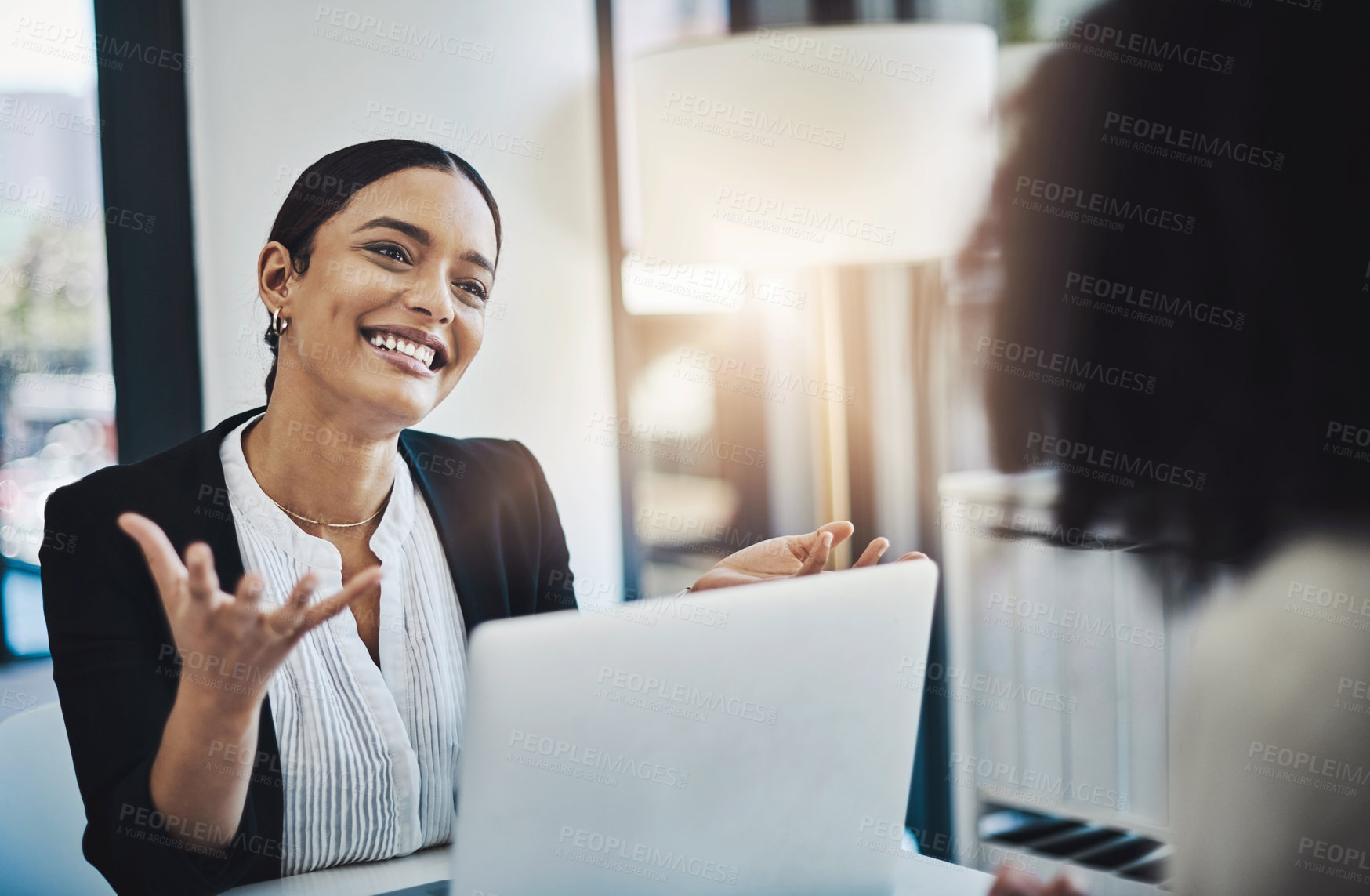 Buy stock photo Shot of two businesswomen having a discussion in an office