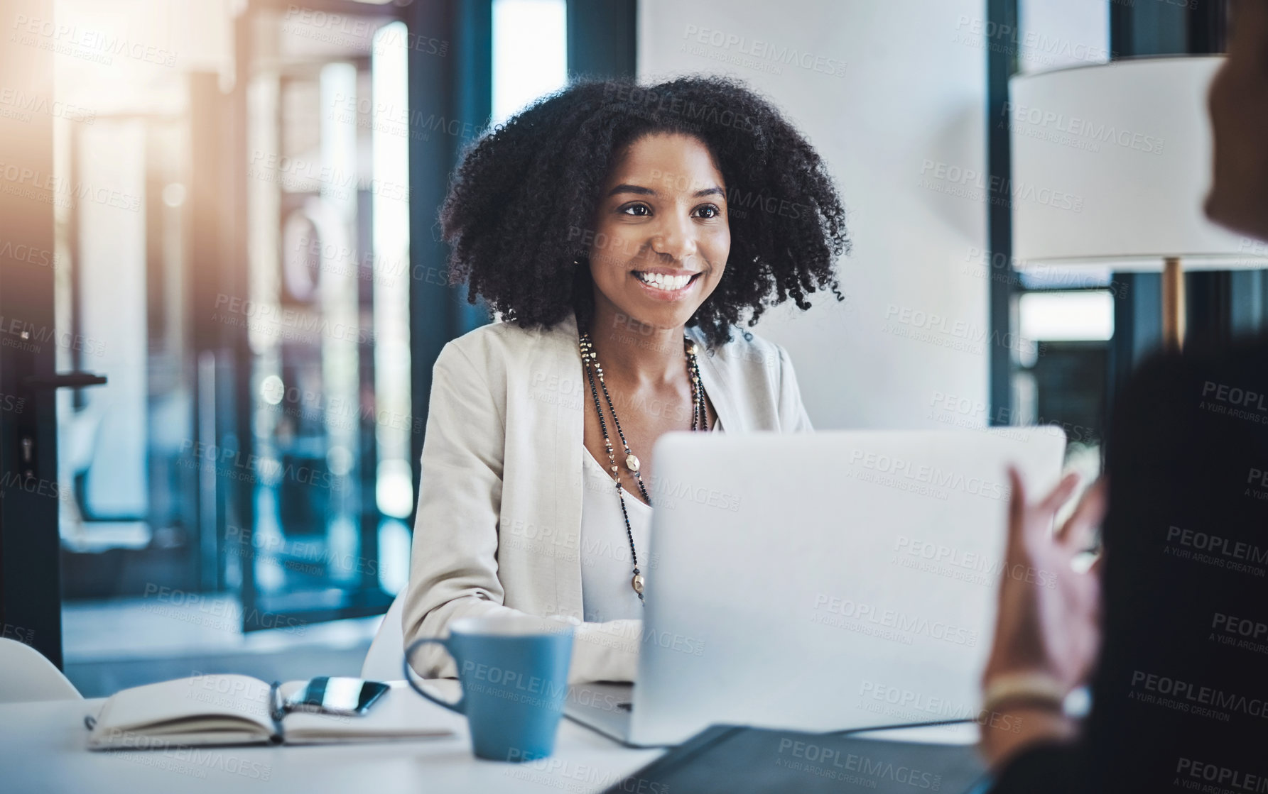 Buy stock photo Shot of two businesswomen having a discussion in an office