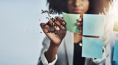 Buy stock photo Closeup shot of a businesswoman brainstorming notes on a glass wall in an office