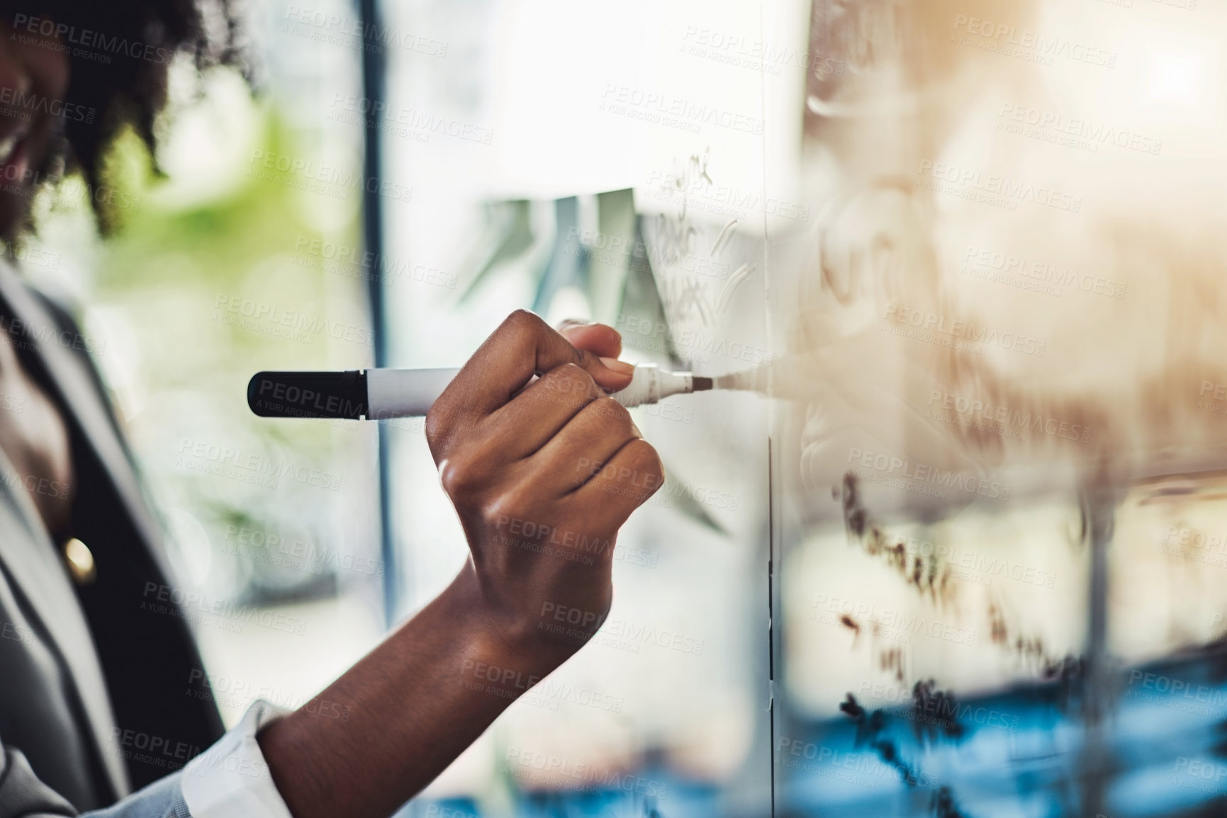 Buy stock photo Closeup shot of a businesswoman brainstorming notes on a glass wall in an office