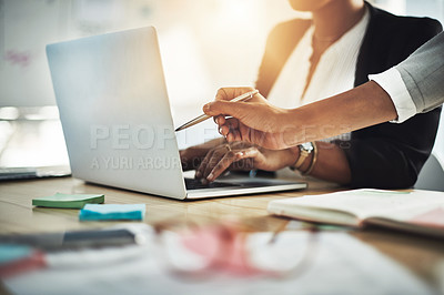 Buy stock photo Closeup shot of two businesswomen working together on a laptop in an office