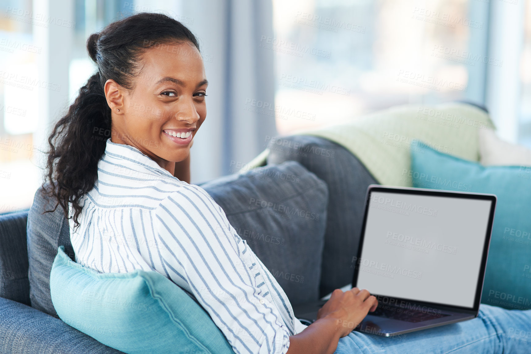 Buy stock photo Portrait of a young woman using a laptop at home