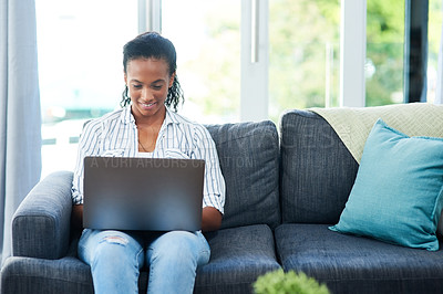 Buy stock photo Typing, woman and laptop on sofa in home for scholarship, digital and communication as journalism student. Female person, tech and positive for online learning, education and connection for research