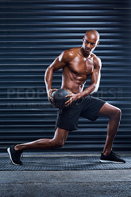 Buy stock photo Shot of a masculine man working out with a medicine ball