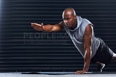 Buy stock photo Shot of a handsome young man doing push-ups