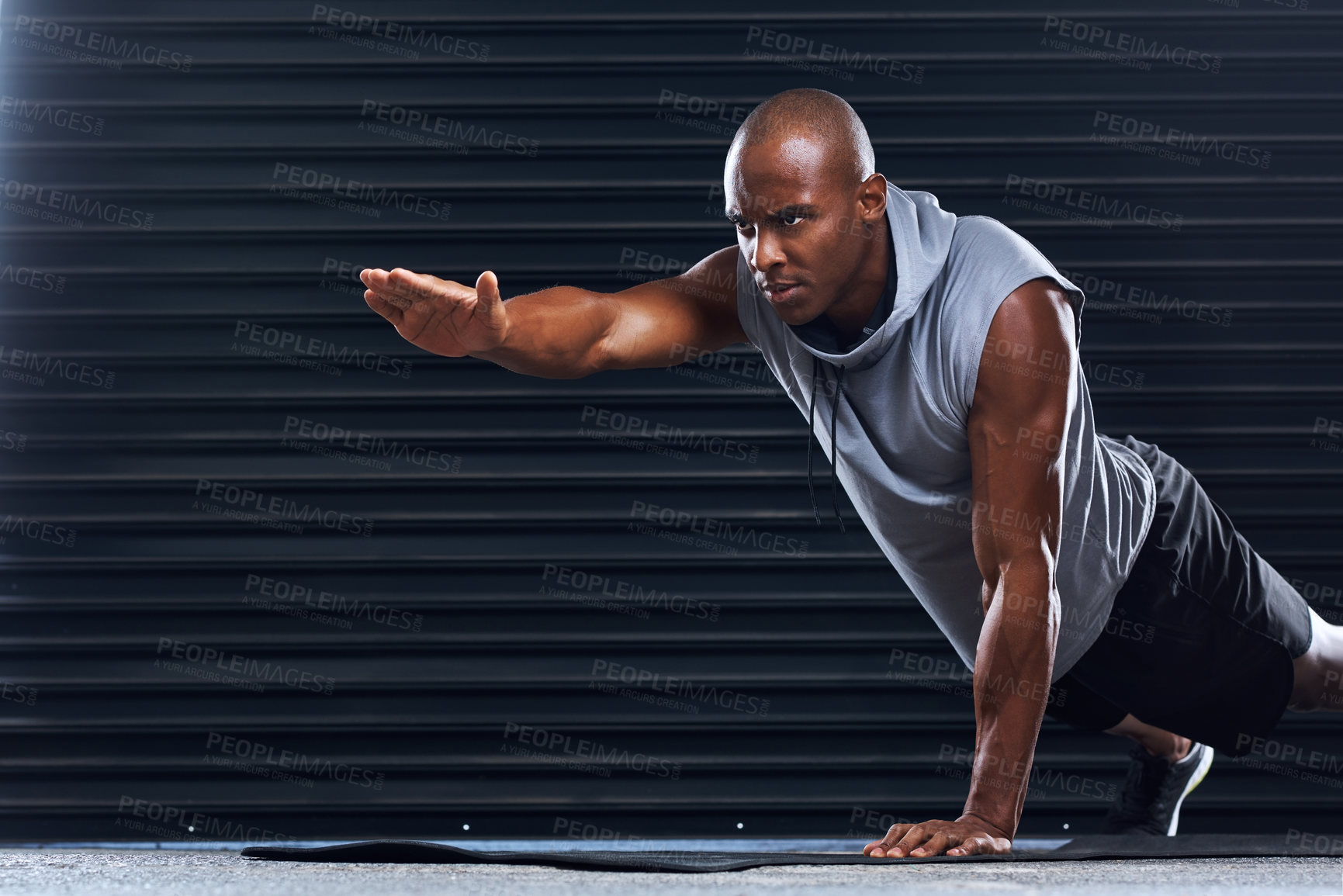 Buy stock photo Male athlete, exercise and pushup with hand for balance, sport or toning in fitness studio. Healthy, African man and challenge in core workout for wellness, muscle or strength training as bodybuilder