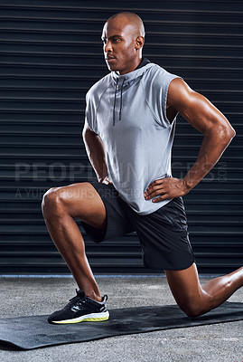 Buy stock photo Shot of a sporty young man practising his exercise routine