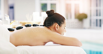Buy stock photo Woman, relax and rock massage at spa for zen, physical therapy or treatment at the resort. Happy female person relaxing with hot stone back for muscle relief, tension or peaceful wellness at a salon
