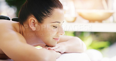 Buy stock photo Woman, relax and sleeping in rock massage at spa for zen, physical therapy or treatment at resort. Happy and calm female person relaxing with hot stone for stress relief, peace or wellness at a salon