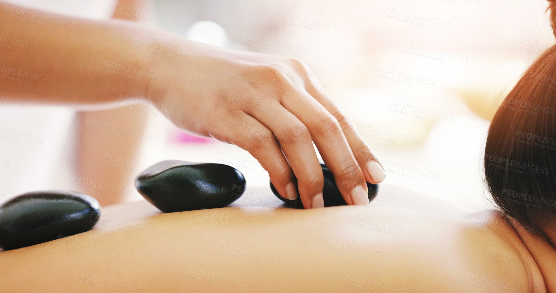 Buy stock photo Woman, hands and rock massage at spa in relax for zen, physical therapy or treatment at resort. Hand of masseuse and female person with hot stone back for muscle relief, peace or wellness at a salon