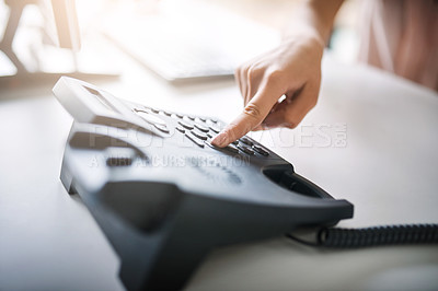 Buy stock photo Cropped shot of an unrecognizable businesswoman using the landline at work