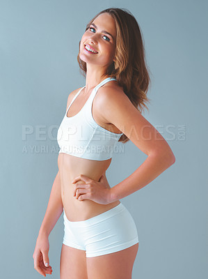 Buy stock photo Underwear, waist and portrait of woman in studio with healthy body, diet progress and weight loss. Slim, stomach and female person with confidence for detox, pride and self care on blue background