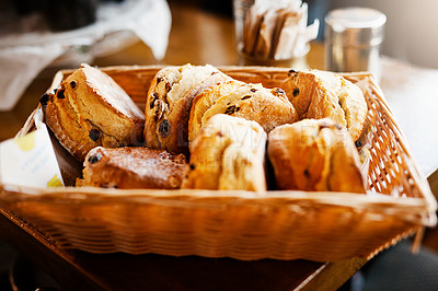 Buy stock photo Scones, food and basket in closeup at bakery, diner and service with catering, pastry or order in morning. Container, snack or breakfast at store, cafeteria or coffee shop with dessert on countertop