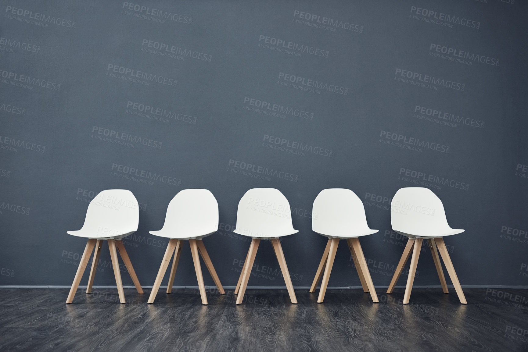 Buy stock photo Recruitment, chairs and row on gray wall with vacancy, waiting room and job interview. Hiring, background and employment with company interior, work opportunity and queue for human resources line