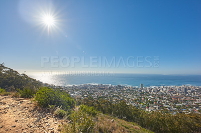Buy stock photo Copy space with views from Table Mountain in Cape Town South Africa of a clear blue sky over a coastal city. Scenic landscape of buildings in an urban town along the mountain and sea on a sunny day