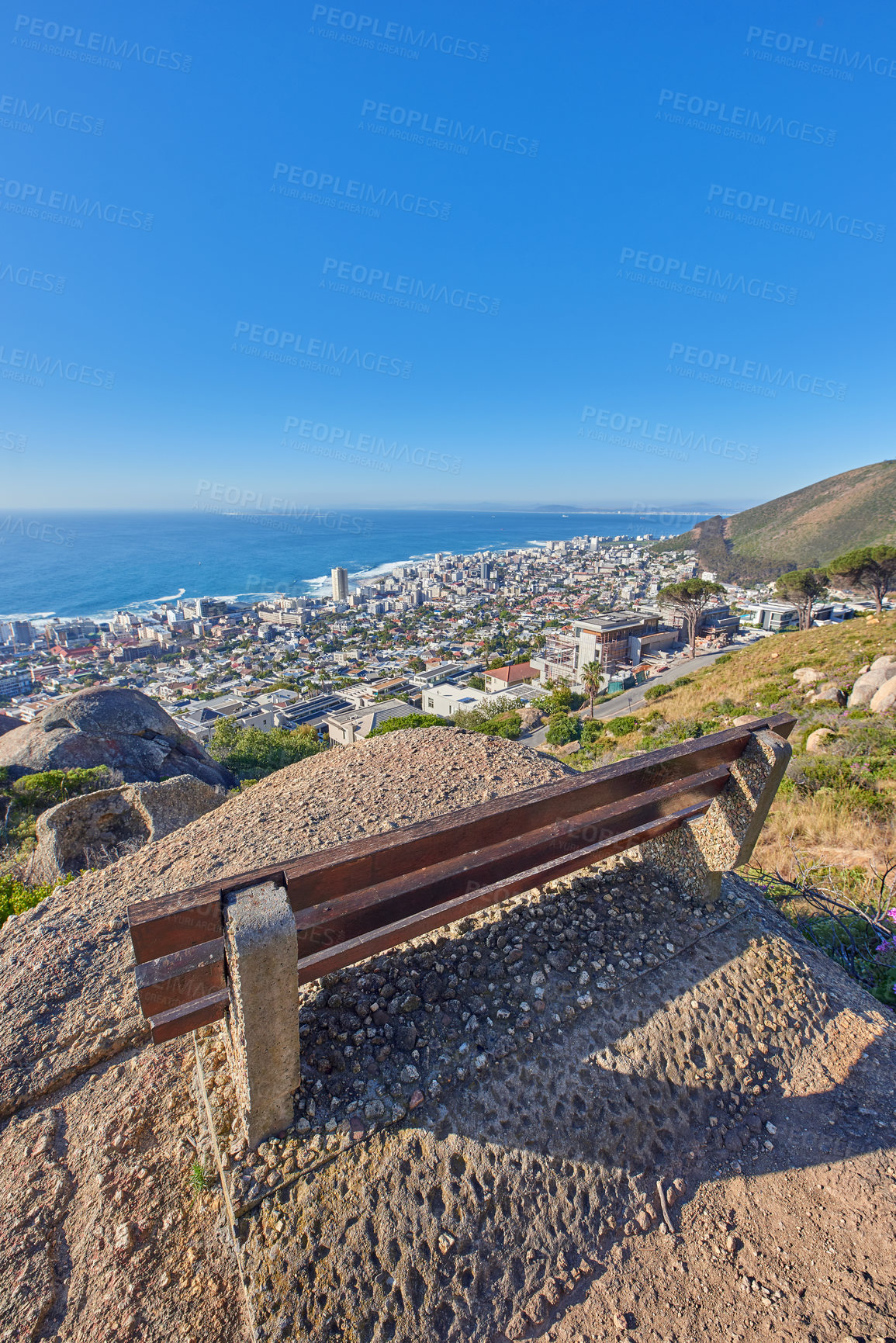 Buy stock photo Bench near a cliff on the mountains overlooking the ocean on a blue sky with copy space. Landscape of an outdoor seat area on a mountaintop with breathtaking view of nature in Cape Town, South Africa