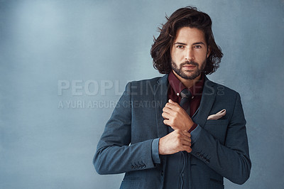 Buy stock photo Studio shot of a handsome and dapper young man posing against a grey background