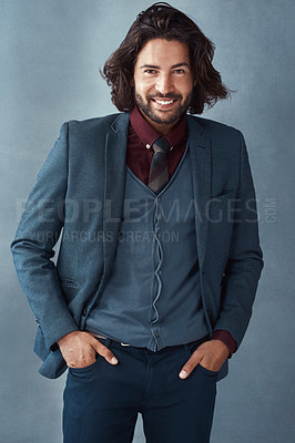 Buy stock photo Studio shot of a handsome and dapper young man posing against a grey background