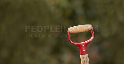 Buy stock photo Closeup of a shovel handle in a garden outside against a blur background. Red gardening tool or equipment ready to be used in a backyard for shoveling, planting and basic outdoor maintenance