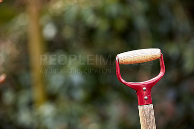 Buy stock photo Closeup of wooden shovel handle in a garden or field with copyspace . Zoom in on macro details, patterns and shape of a gardening tool ready to be used in springtime. Digging made easier with tools