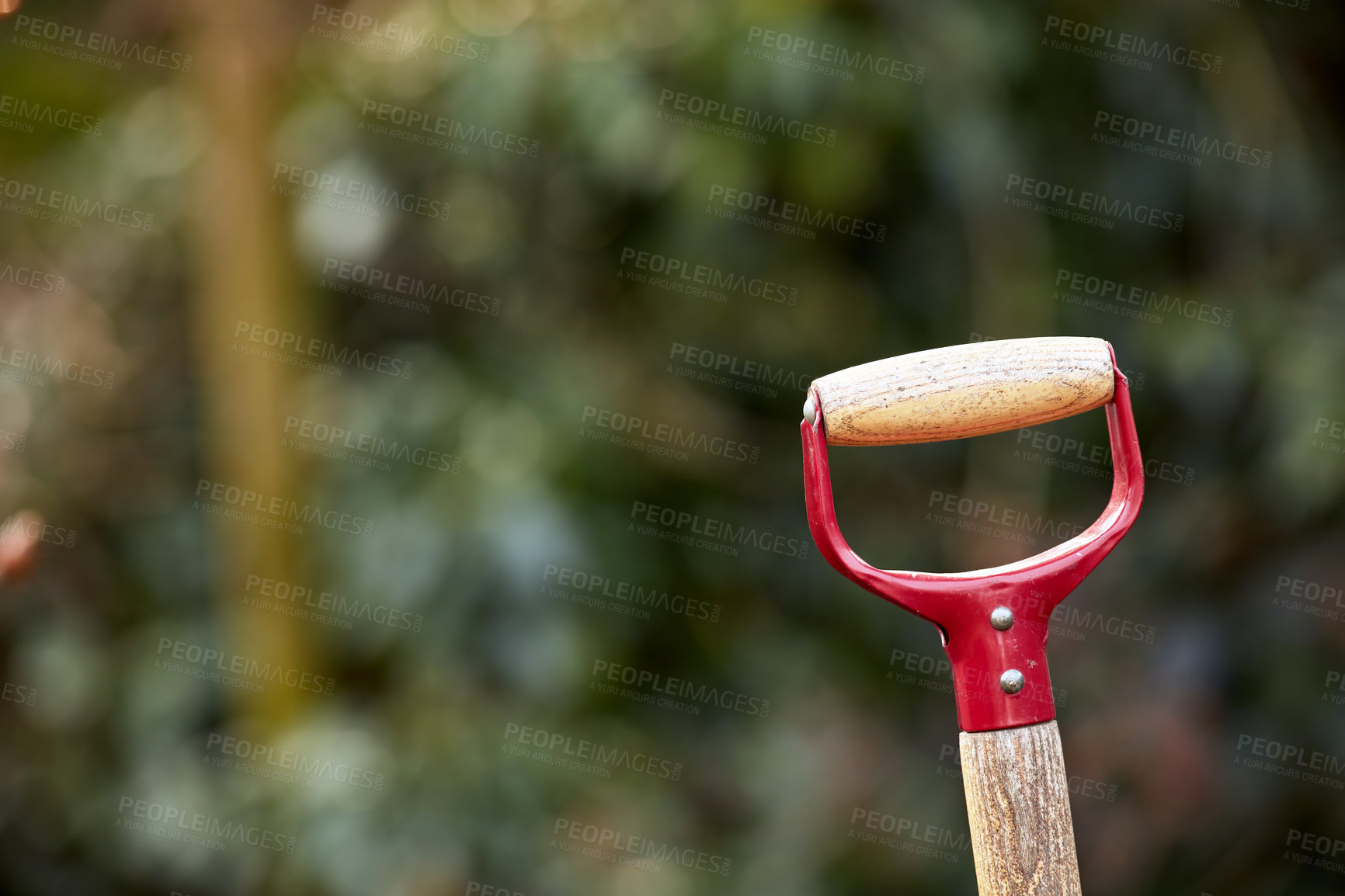 Buy stock photo Closeup of wooden shovel handle in a garden or field with copyspace . Zoom in on macro details, patterns and shape of a gardening tool ready to be used in springtime. Digging made easier with tools