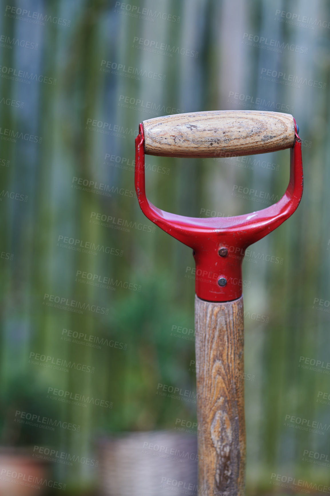 Buy stock photo Closeup of a shovel handle in an empty garden, reqady to be used with copyspace. Zoom in on wooden patterns and texture of a gardening tool with copy space. Garden cleanup made easier with a gadget