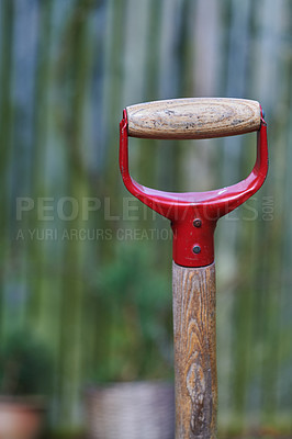 Buy stock photo Closeup of a shovel handle in an empty garden, reqady to be used with copyspace. Zoom in on wooden patterns and texture of a gardening tool with copy space. Garden cleanup made easier with a gadget