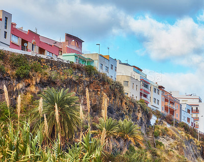Buy stock photo City view of residential houses or buildings on a hill cliff in Santa Cruz, La Palma, Spain. Historical spanish, colonial architecture and palm trees in tropical village of famous tourism destination