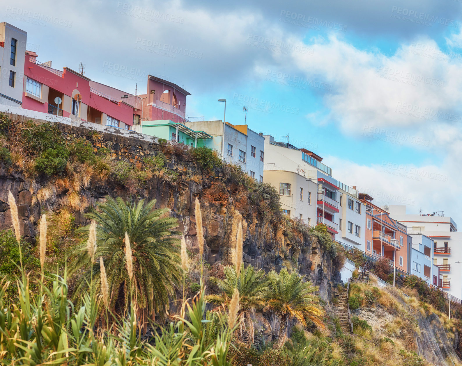 Buy stock photo City view of residential houses or buildings on a hill cliff in Santa Cruz, La Palma, Spain. Historical spanish, colonial architecture and palm trees in tropical village of famous tourism destination