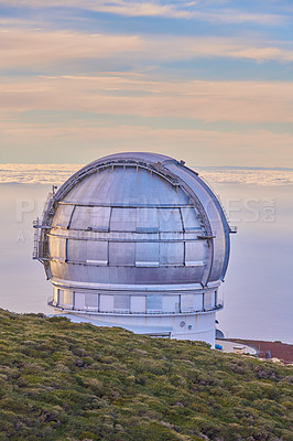 Buy stock photo Scenic view of an astronomy observatory dome in Roque de los Muchachos, La Palma, Spain. Landscape of science infrastructure or building against blue sky with clouds and copyspace abroad or overseas