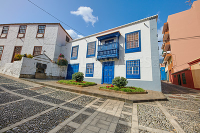 Buy stock photo Colorful homes with a traditional design in the city of Santa Cruz de La Palma. Street in small old town or village with bright and vibrant residential buildings on a cloudy summer day 