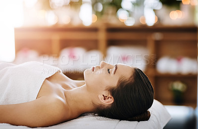 Buy stock photo Beauty, relax and wellness with woman in spa, on bed or table for luxury massage or treatment. Break, rest and stress relief with face of customer in health resort for alternative therapy or healing