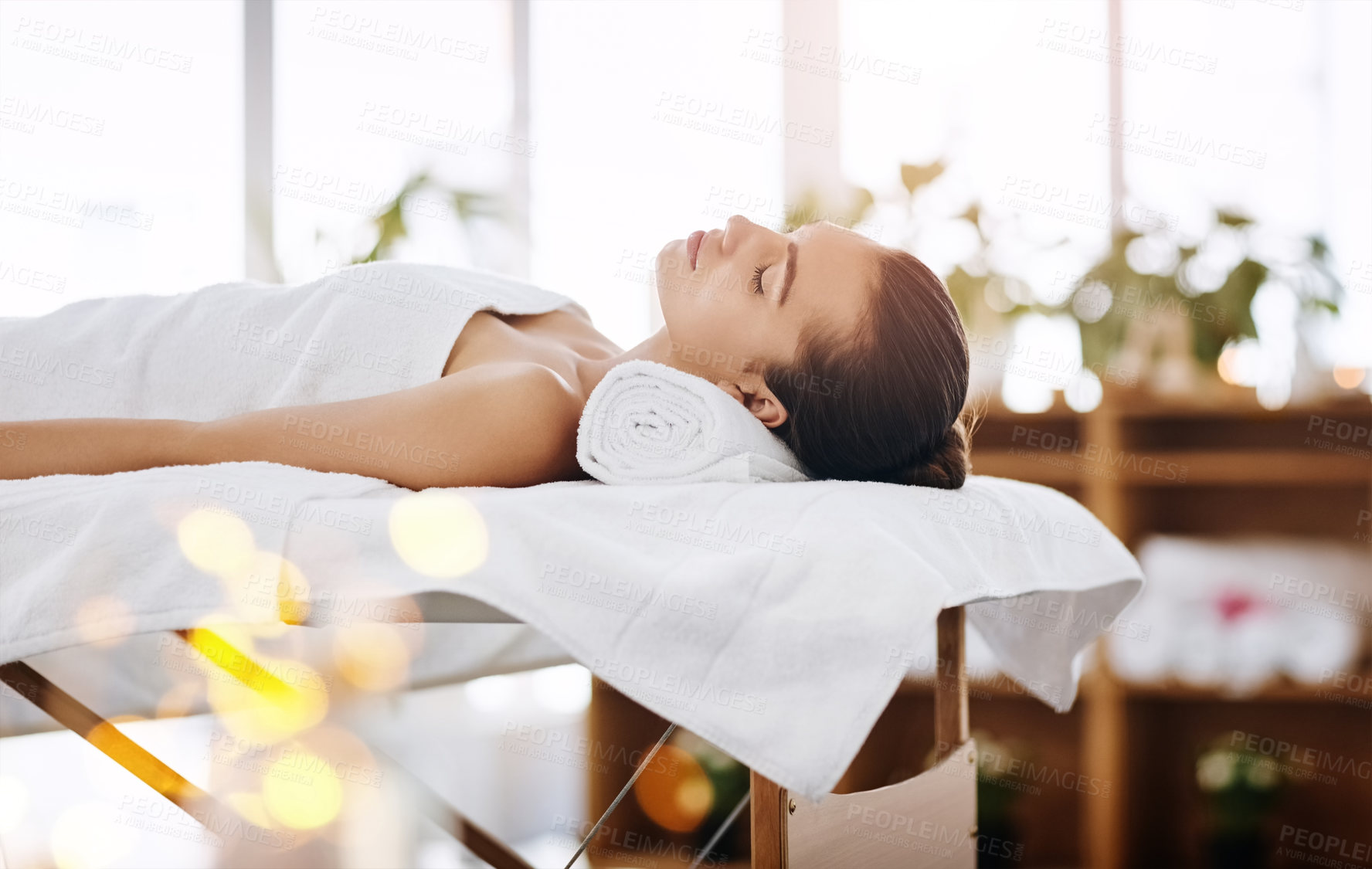 Buy stock photo Woman, rest and relax on towel at spa for luxury treatment, chemical peel and body massage for pamper. Bokeh, sleeping and wellness at beauty salon with zen, serene and cosmetic facial for skincare